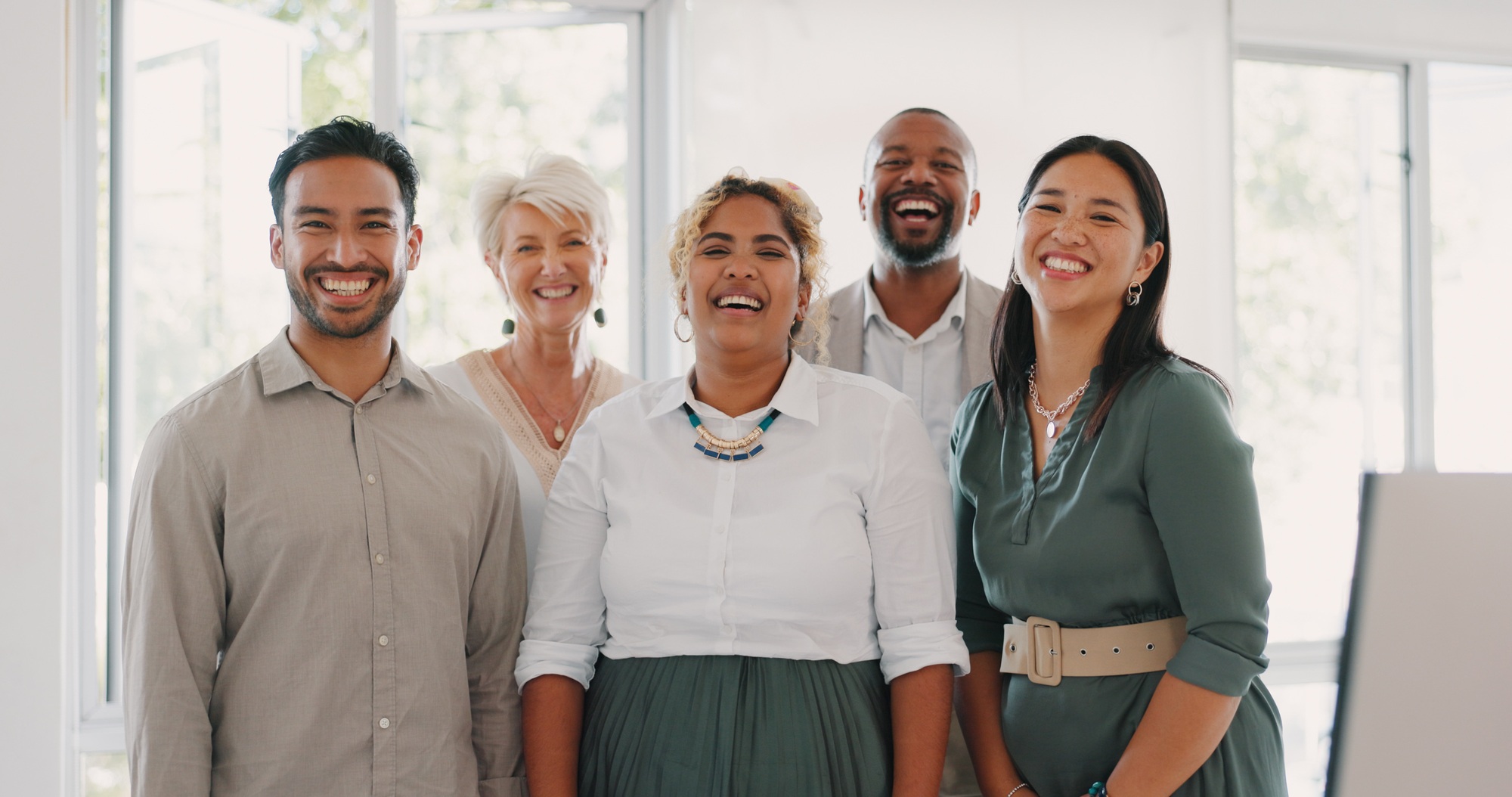 Collaboration, motivation and mindset with a business team posing for a photograph together in the