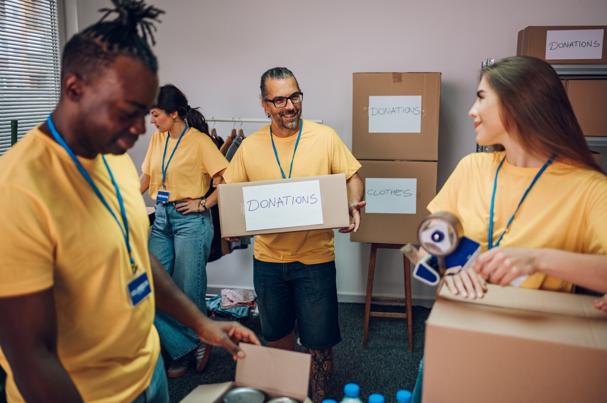 Group of multiracial volunteers working in community charity donation center